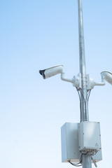 outdoor camcorder surveillance camera on the pillar summer day
