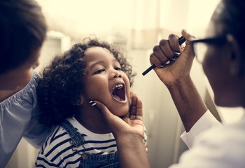 Little girl having her teeth checked