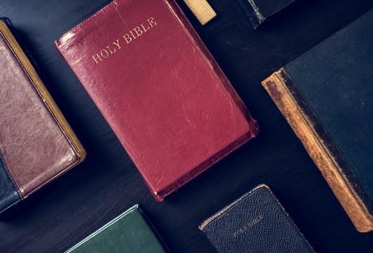 Diverse holy bible on black background