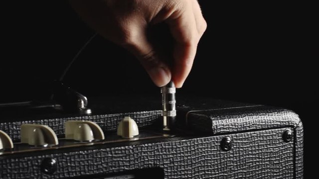 Guitar Amplifier Being power up, guitar cable plugged in and knobs turned. Plus two clips of guitars being played.