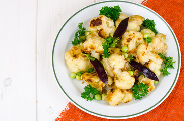 Vegetarian dish with cauliflower and peas