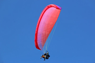 Tandem paraglider flying