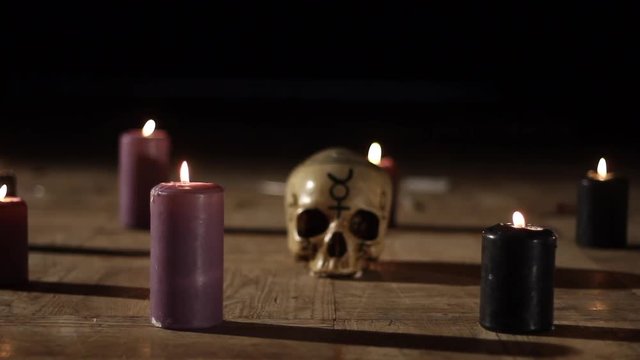 Satanic ceremony, focus change skull and candles