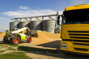 front end loader of grain from a pile to a truck