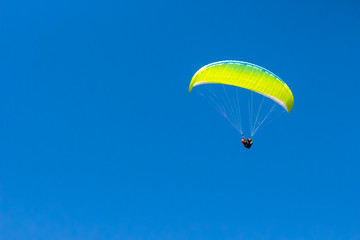 Paraglider isolated in blue sky