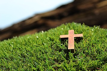 Blurred image. Christian crosses made of wood on a green background.