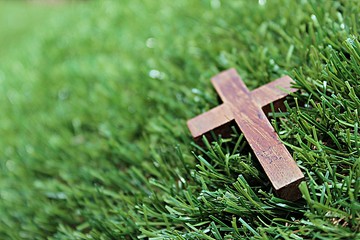Blurred image. Christian crosses made of wood on a green background.