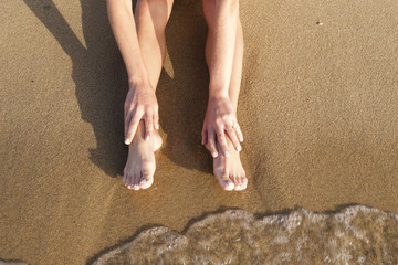 Female legs on sand