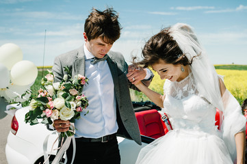 Happy bride and groom near the car. The best wedding day and marriage. Just married.