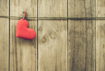Red paper heart hanging on the clothesline.