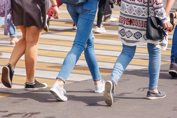 Fototapeta na wymiar young woman feet, crossing an urban street