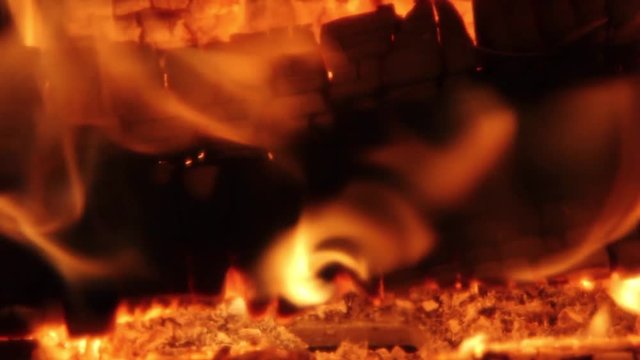 Burning Firewood Coal Close up in the Fireplace. Fire Fireplace Ember Wood Home Embers Closeup. Glowing Embers in Hot Red Collor. static tripod shoot.