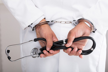 Doctor's hand with handcuff
