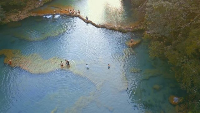 Aerial Fly Over of people swimming at Semuc Champey pools