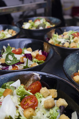 Greek salad served in black plates.