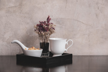 Coffee cup with flower in vintage style.