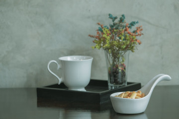 Coffee cup with flower in vintage style.