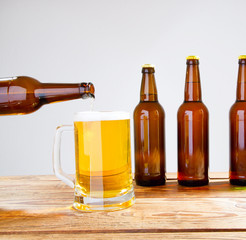 glass of beer on wooden table, top view. Beer bottles. Selective focus. Mock up. Copy space.Template. Blank.
