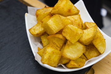 fried potatoes in white ceramic bowl