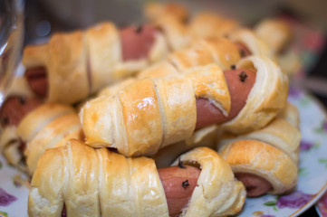 Sausage mummies in dough scary halloween food celebration party with funny eyes