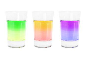 set shot glass with iridescent alcohol cocktails on a white background isolated