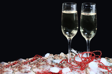 Glasses of champagne decorated, on a black background