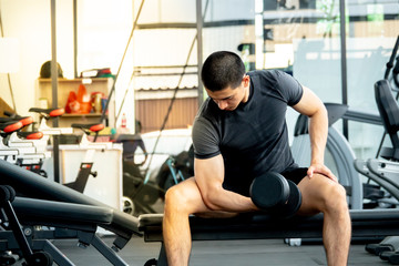 Young sport man exercising in fitness gym