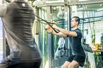 Obraz na płótnie Canvas Young sport man exercising in fitness gym