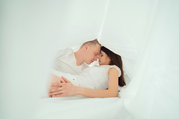 couple kisses under the sheet