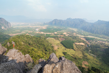 Fototapeta na wymiar Scenic view of Vang Vieng and the surrounding area from above from the Phangern (Pha Ngern, Pha ngeun) mountain in Laos on a sunny day.