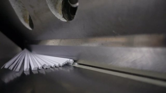 Paper cutting process, close-up, big industrial cutter for cutting paper shears - guillotine machine. Slow motion 250FPS
