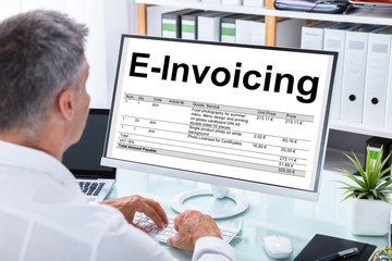 Businessman Preparing E-invoicing Bill On Computer