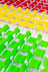 Obraz premium Rows of bright color chairs arranged in meeting room ready to sit. high angle shoot.