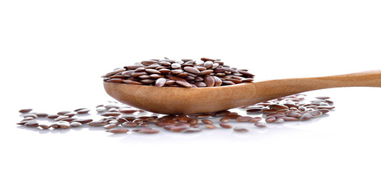 Flax seeds in wood on white background