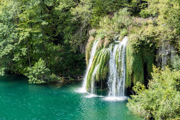 Fototapeta na wymiar Waterfalls in Plitvice National Park - Croatia. Plitvice Lakes National Park is one of the oldest and the largest national park in Croatia. In 1979, it was added to the UNESCO World Heritage register.