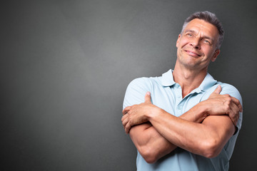 Portrait Of A Mature Man Hugging Himself
