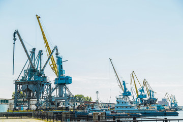 Port cargo crane against blue sky