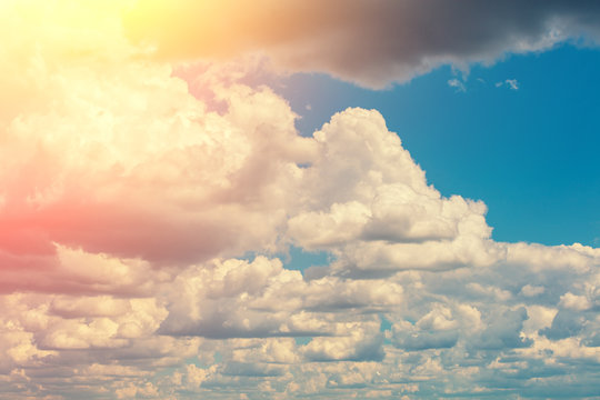 Beautiful cloudy sky background. The sun shines through the clouds © vvvita