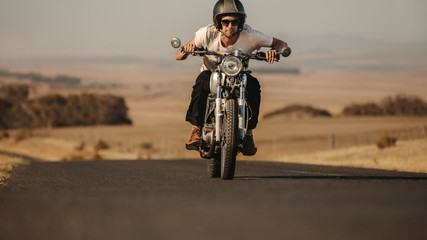 Fototapeta na wymiar Man riding on a fast motorcycle