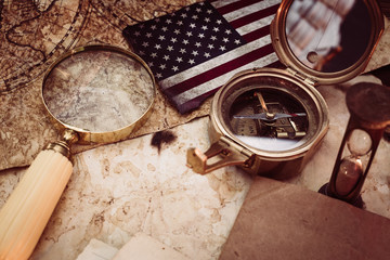 Old maps with marine equipment like compass, magnifier or hourglass and blank vintage paper for your inscript. Columbus Day concept.