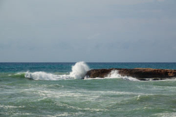White ocean waves crashing to rocks