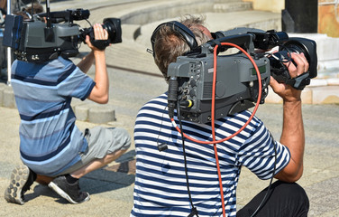 Cameramen works outdoor in summer time