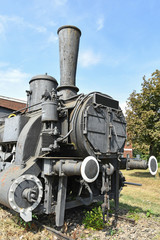 Fototapeta na wymiar Front part of an old rusty locomotive