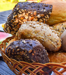 Basket with different healthy bread rolls with grains