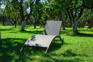 chaise lounge on the sunny lawn.