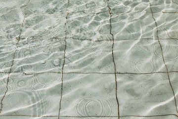 Waves and water splashes in the marble fountainWaves and water splashes in the marble fountain