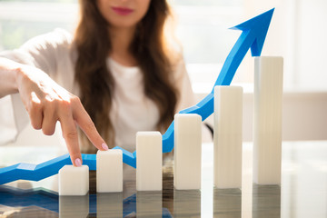 Businesswoman Climbing Increasing Graph With Her Fingers