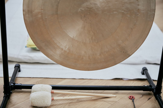 A large brass gong used for sound therapy