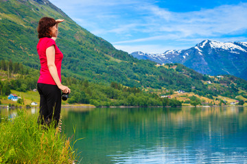 Fototapeta na wymiar Tourist woman enjoying fjord view in Norway