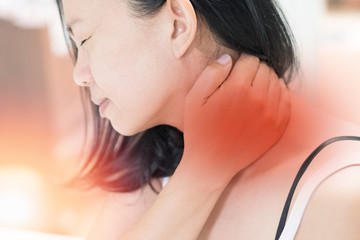 Neck pain disease concept. Asian female hand on her neck as suffering from office syndrome neck ache